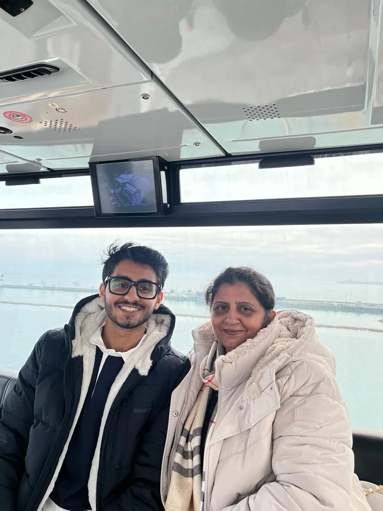 Ayush and his mother together on a winter gondola ride