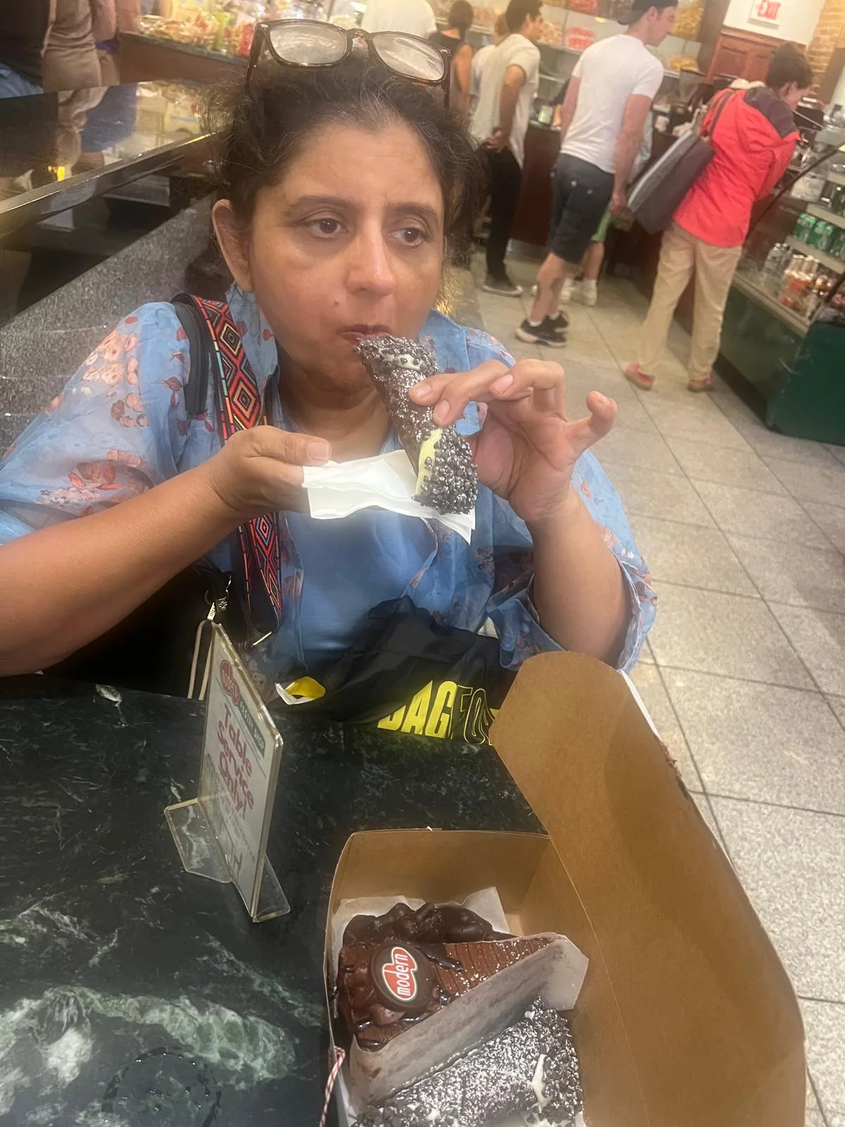 Ayush's mother enjoying a chocolate dessert