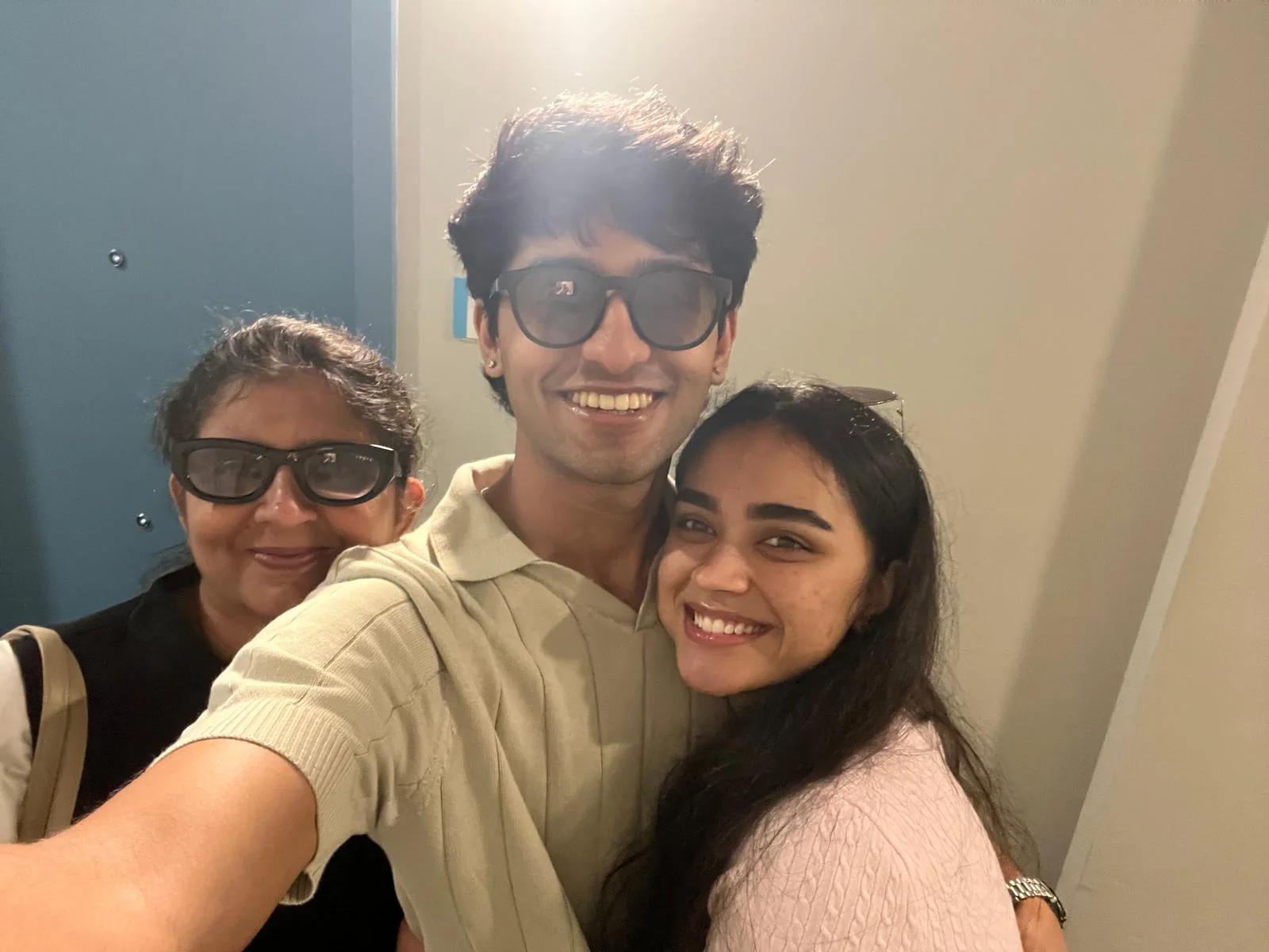 Ayush, his mother, and a loved one smiling together