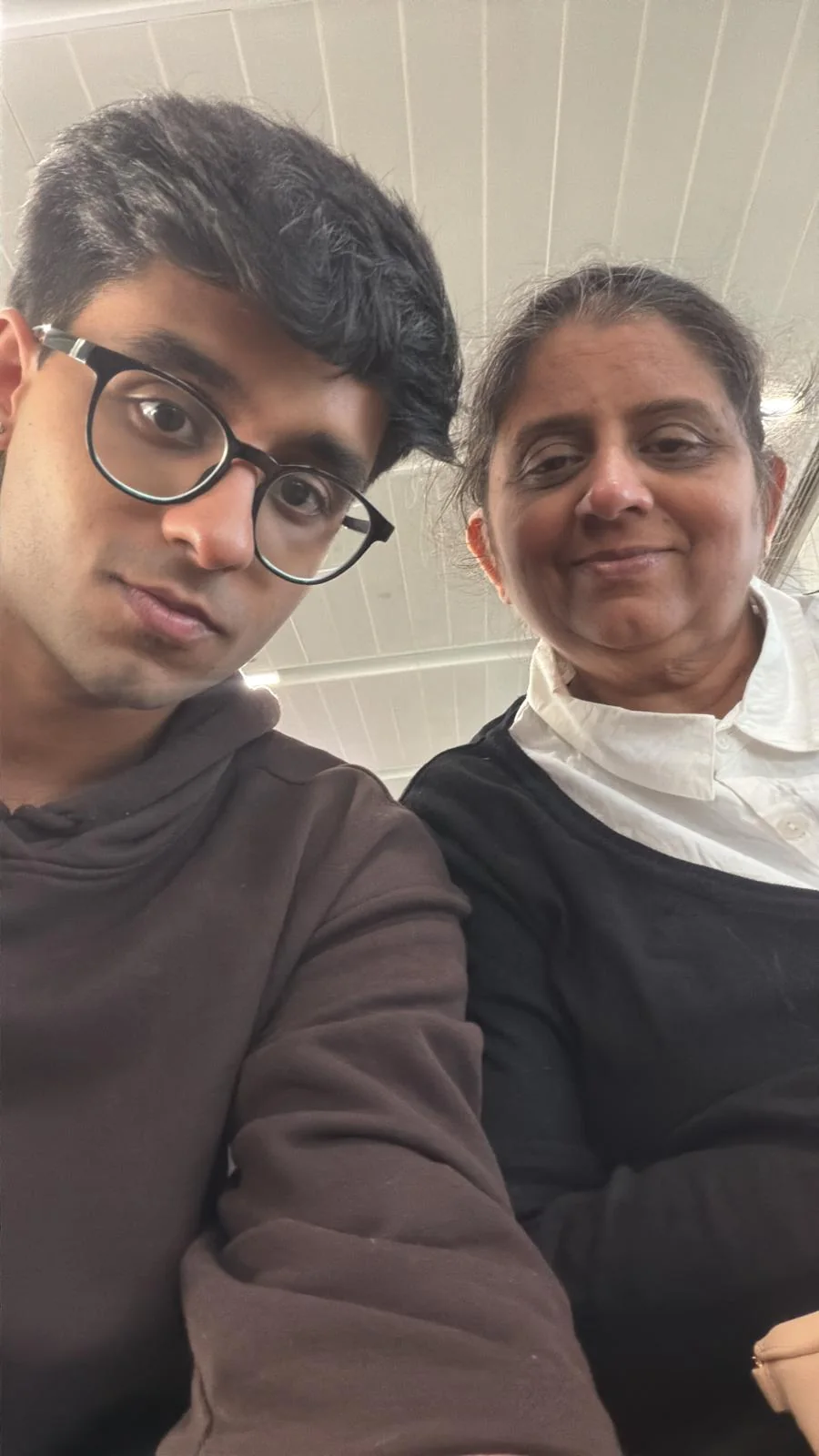 Ayush and his mother taking a playful low-angle selfie